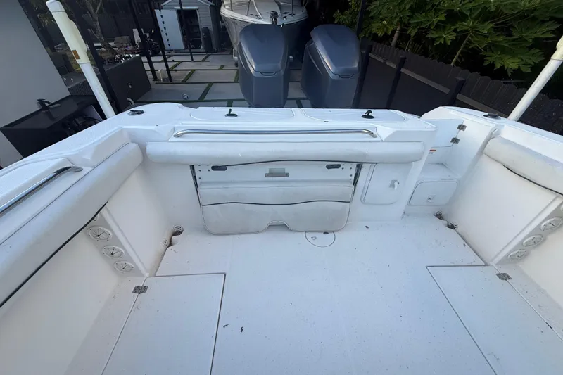 Slide: The Image of 2004 Wellcraft 32 CCF boat interior with white seating and dual outboard motors. - 75
