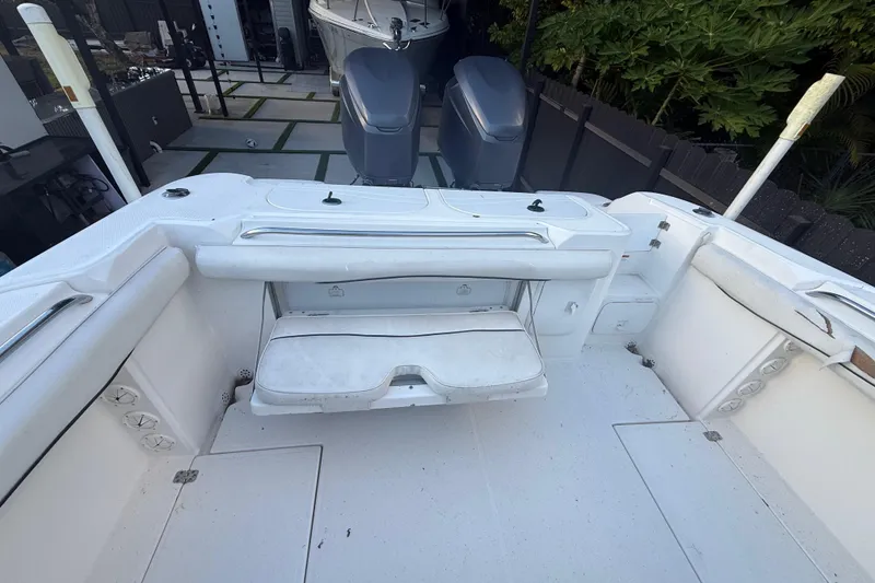 Slide: The Image of 2004 Wellcraft 32 CCF boat interior with seating and dual outboard motors. - 76