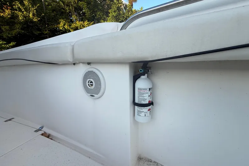 Slide: The Image of 2004 Wellcraft 32 CCF boat interior with fire extinguisher and speaker. - 84