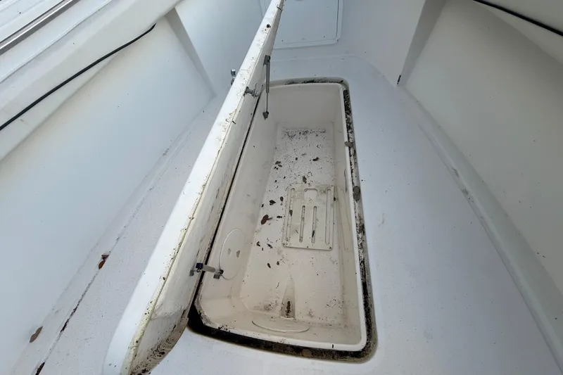 Slide: The Image of Open storage compartment on 2004 Wellcraft 32 CCF boat, showing interior details. - 86