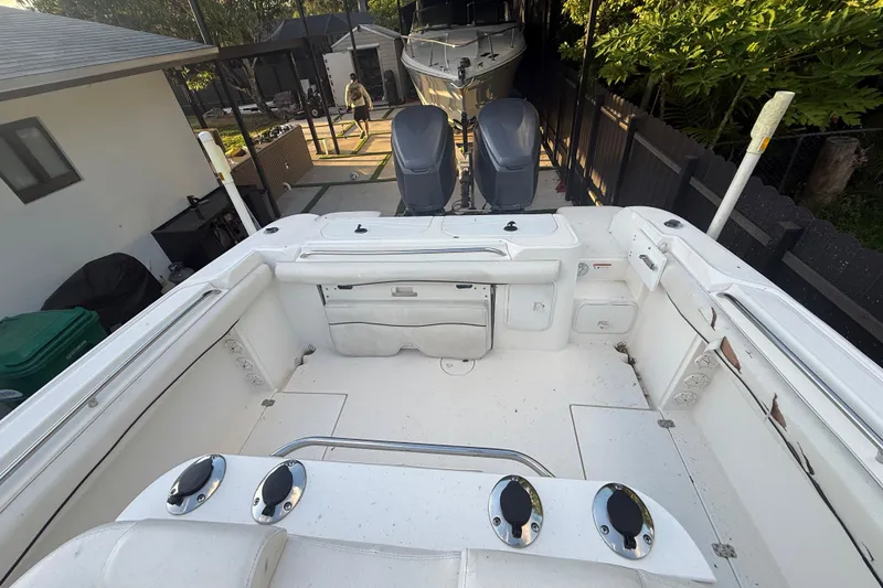 Slide: The Image of 2004 Wellcraft 32 CCF boat interior with dual engines, docked in a residential area. - 88