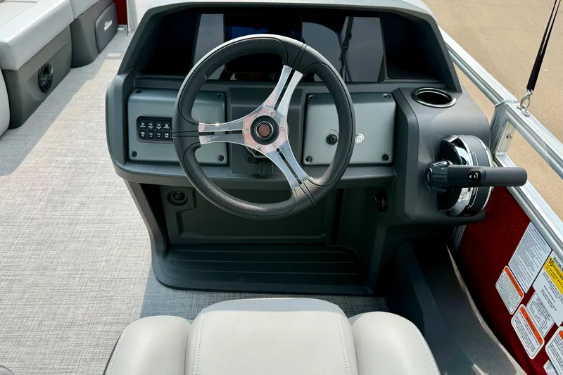 Slide: The Image of Steering console of 2026 Sun Tracker SportFish 22 DLX pontoon boat, featuring modern controls. - 13