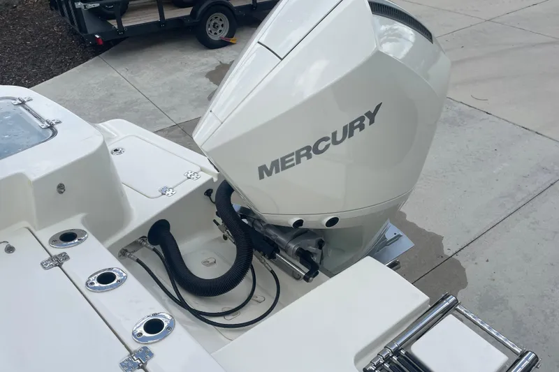 Slide: The Image of 2026 Mako 226 Center Console boat with Mercury outboard engine on a concrete surface. - 11
