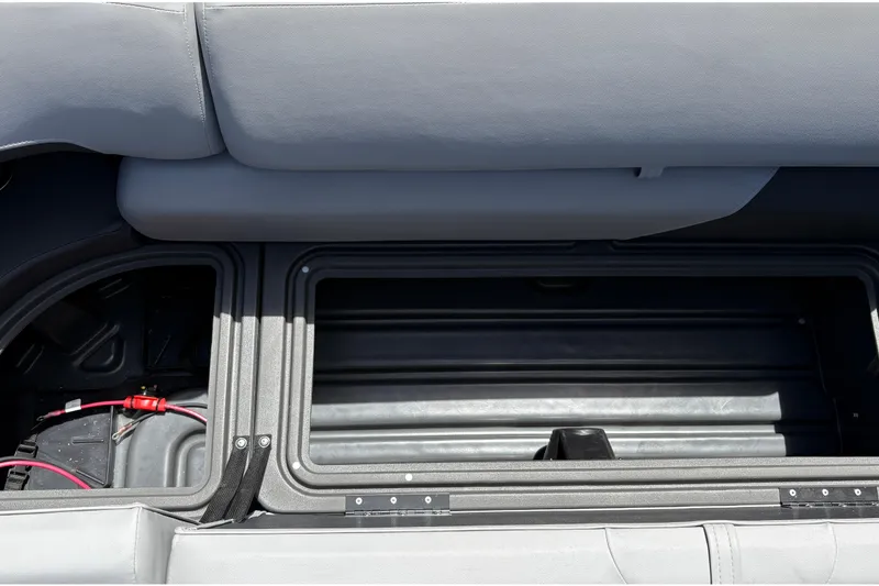 Slide: The Image of Open storage compartment in 2026 Sun Tracker SportFish 22 DLX boat, showcasing interior details. - 18
