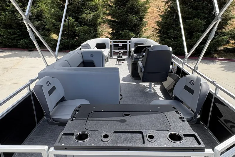 Slide: The Image of 2026 Sun Tracker SportFish 22 DLX pontoon boat interior with seating and helm. - 11