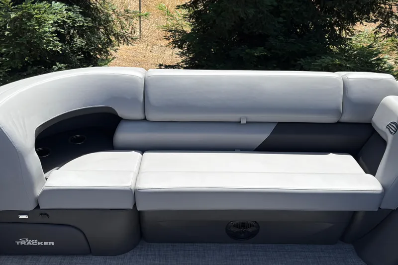 Slide: The Image of 2026 Sun Tracker SportFish 22 DLX boat seating with gray upholstery and cup holders. - 17