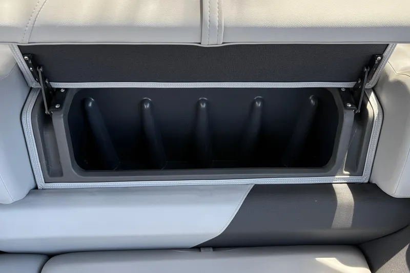 Slide: The Image of Storage compartment in 2026 Sun Tracker SportFish 22 DLX boat seat, open and empty. - 29