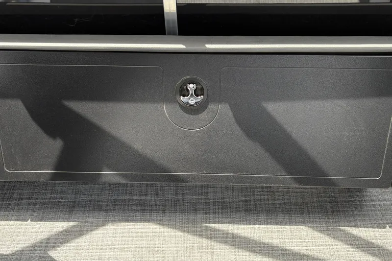 Slide: The Image of A black storage compartment with a round handle on a boat. - 35