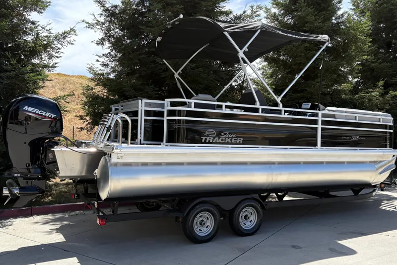 Slide: The Image of 2026 Sun Tracker SportFish 22 DLX pontoon boat with Mercury engine on trailer. - 4