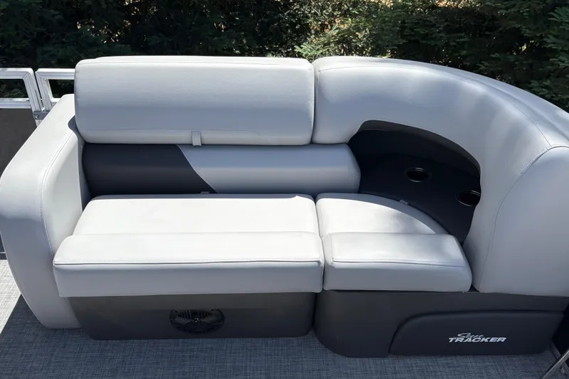 Slide: The Image of 2026 Sun Tracker SportFish 22 DLX boat seating with gray upholstery and cup holders. - 16