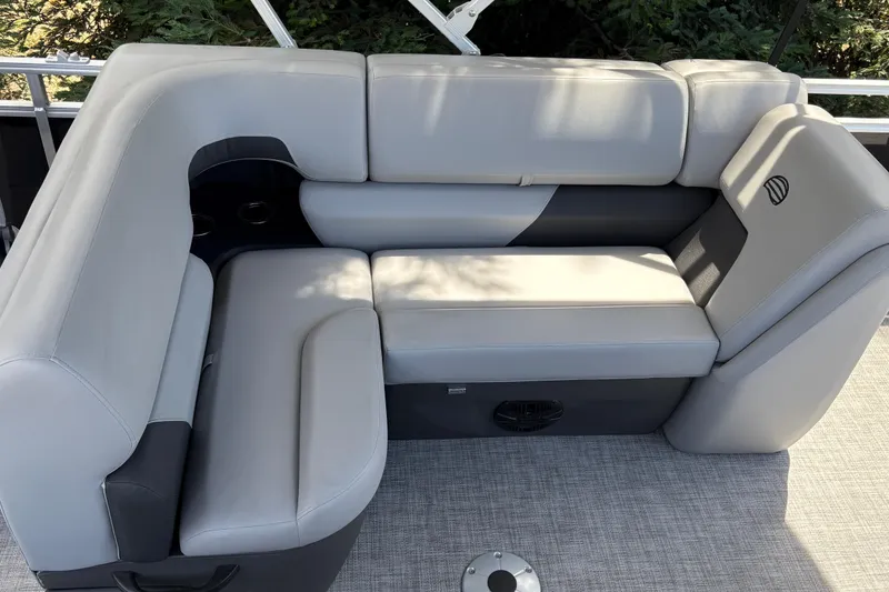 Slide: The Image of Luxurious seating on 2026 Sun Tracker SportFish 22 DLX pontoon boat, featuring plush gray upholstery. - 28
