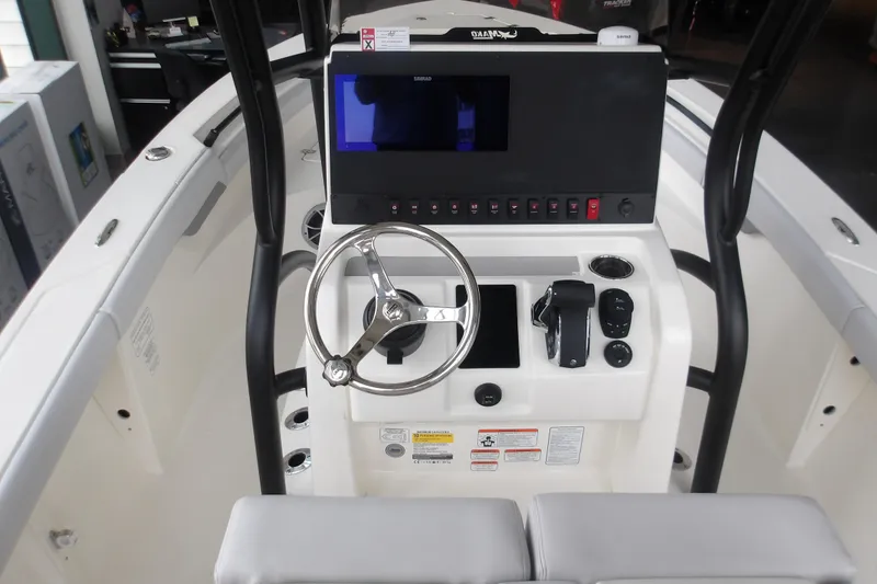 Slide: The Image of 2026 Mako 226 Center Console boat dashboard with steering wheel and control panel. - 33