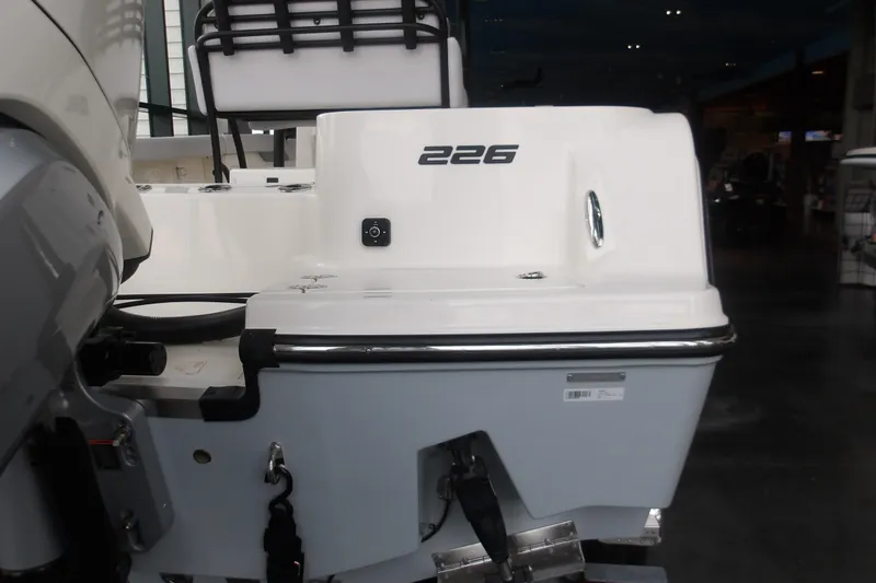 Slide: The Image of 2026 Mako 226 Center Console boat rear view in showroom setting. - 35