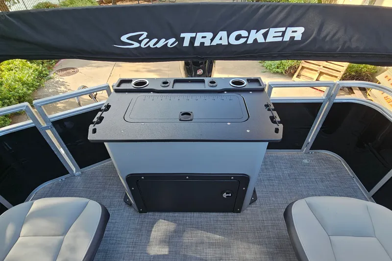 Slide: The Image of 2026 Sun Tracker SportFish 22 DLX boat interior with seating and storage area. - 13