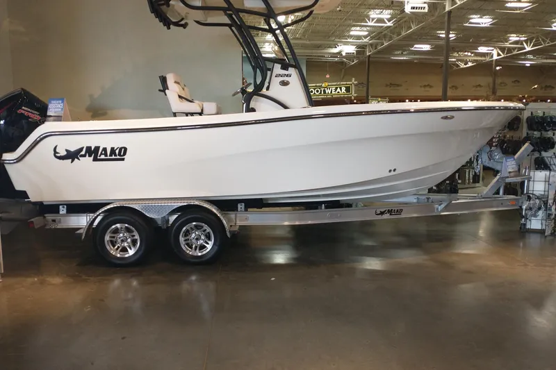 The Image of 2026 Mako 226 Center Console boat on trailer in showroom. - 0