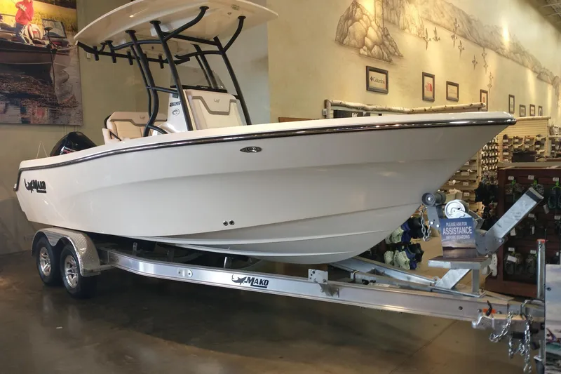 Slide: The Image of 2026 Mako 226 Center Console boat on trailer in showroom setting. - 1