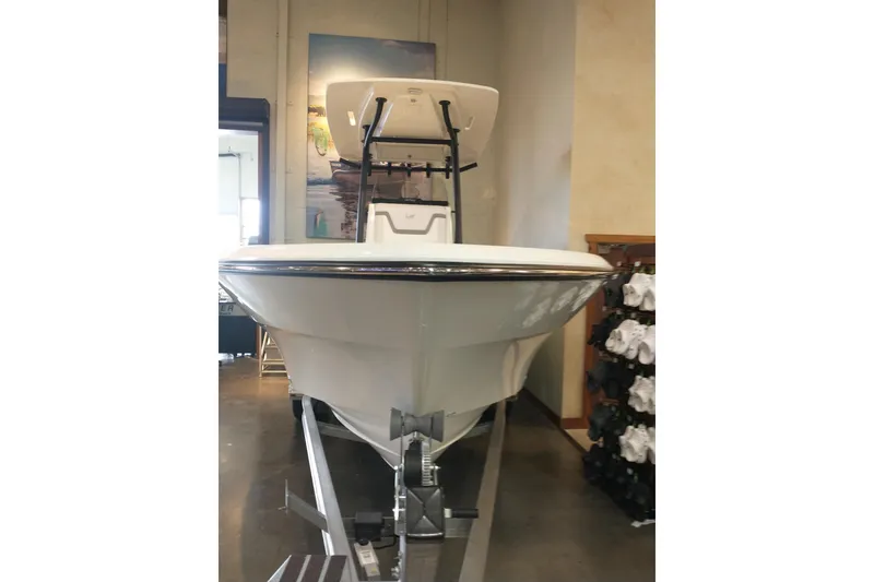 Slide: The Image of 2026 Mako 226 Center Console boat displayed indoors on a trailer. - 2