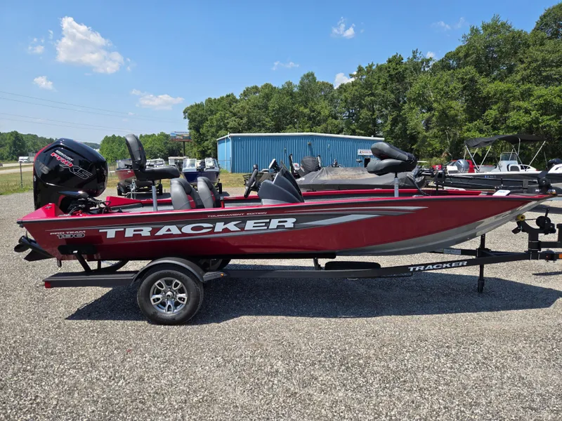 The Image of 2025 Tracker Pro Team 190 boat on trailer, red hull, sunny day. - 0