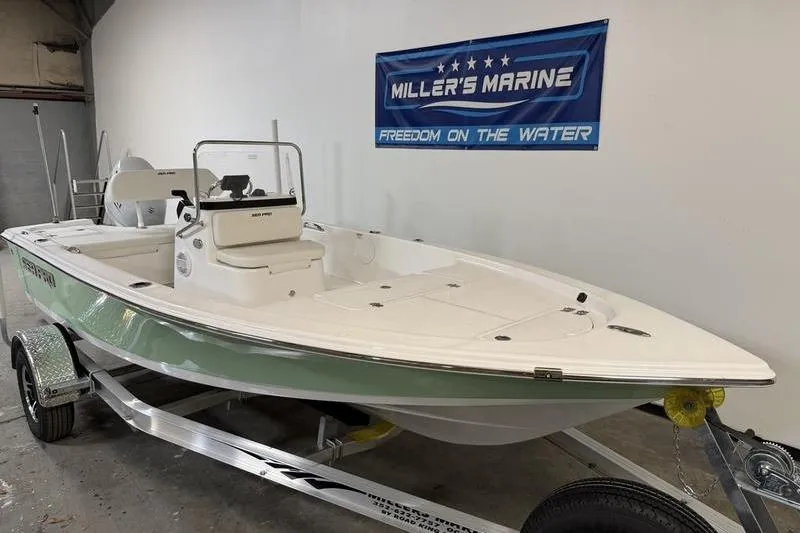 Slide: The Image of 2026 Sea Pro 172 Bay boat on trailer at Miller's Marine showroom. - 2