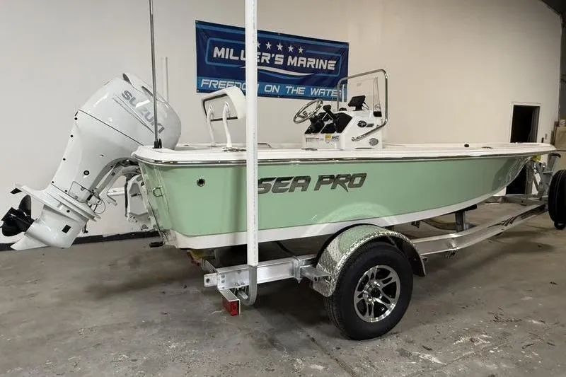 Slide: The Image of 2026 Sea Pro 172 Bay boat on trailer in showroom, featuring Suzuki outboard motor. - 4