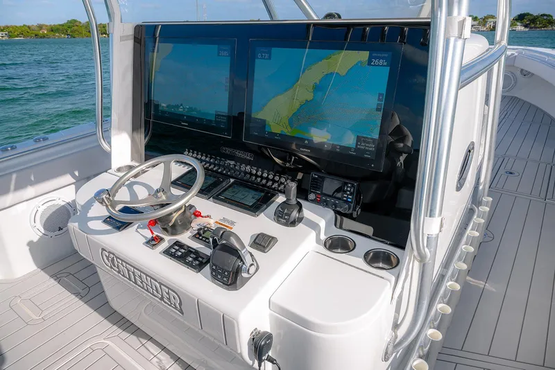 Slide: The Image of 2020 Contender 44 ST boat helm with advanced navigation screens and controls. - 10