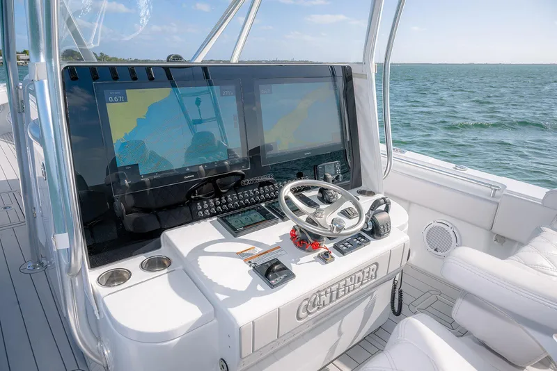Slide: The Image of 2020 Contender 44 ST boat cockpit with advanced navigation systems and steering wheel. - 11