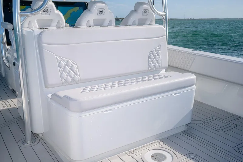 Slide: The Image of 2020 Contender 44 ST boat interior with white cushioned seating and ocean view. - 13