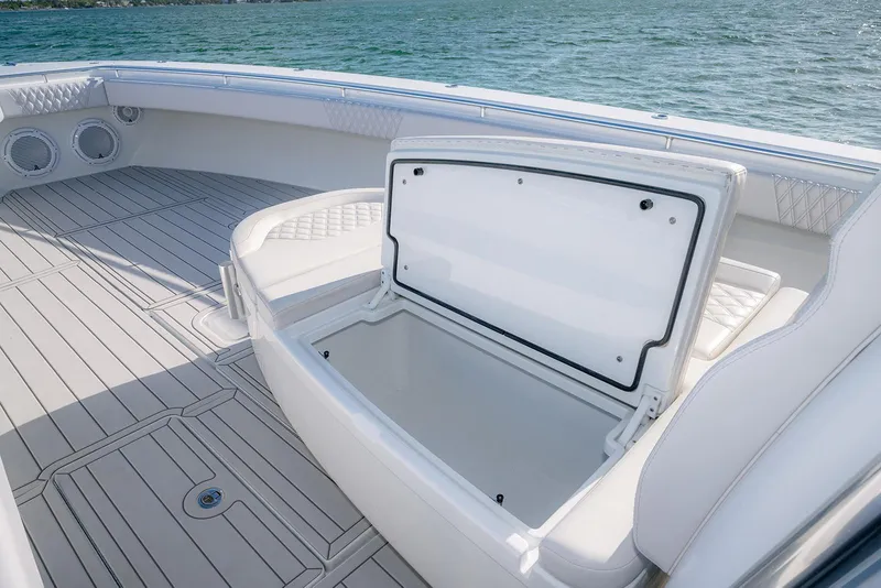 Slide: The Image of 2020 Contender 44 ST boat with open storage compartment on deck, near water. - 19