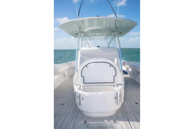 Slide: The Image of 2020 Contender 44 ST boat with open storage compartment, ocean backdrop, and clear sky. - 20