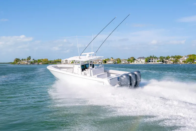 Slide: The Image of 2020 Contender 44 ST boat cruising on a sunny day with triple engines. - 21