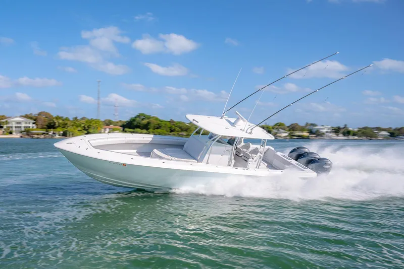 Slide: The Image of 2020 Contender 44 ST boat speeding on water with fishing rods and powerful engines. - 23