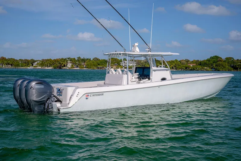Slide: The Image of 2020 Contender 44 ST boat with triple Yamaha engines on a sunny day. - 24
