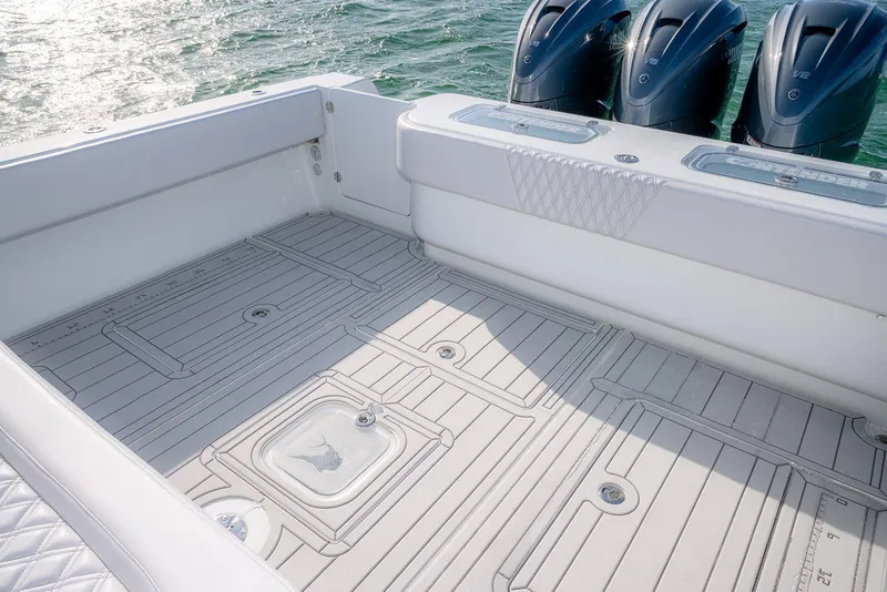 Slide: The Image of 2020 Contender 44 ST boat deck with triple outboard engines, featuring sleek design and spacious layout. - 29