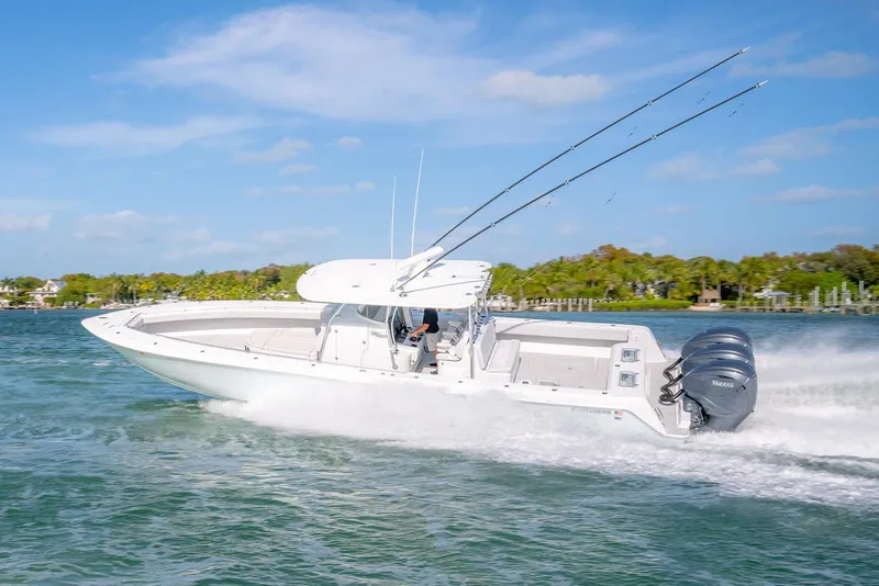 Slide: The Image of 2020 Contender 44 ST boat cruising on clear blue water, equipped with powerful engines. - 3