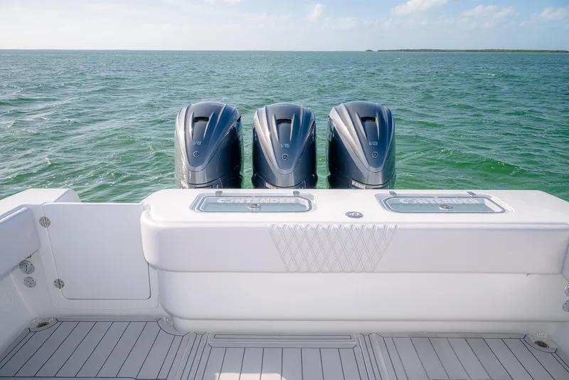 Slide: The Image of 2020 Contender 44 ST boat with triple outboard engines on open water. - 30