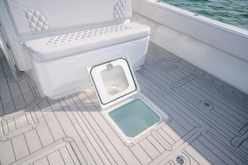 Slide: The Image of 2020 Contender 44 ST boat interior with open storage compartment and cushioned seating. - 33