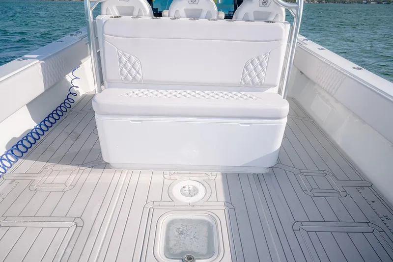 Slide: The Image of 2020 Contender 44 ST boat interior with white seating and deck, on calm water. - 35