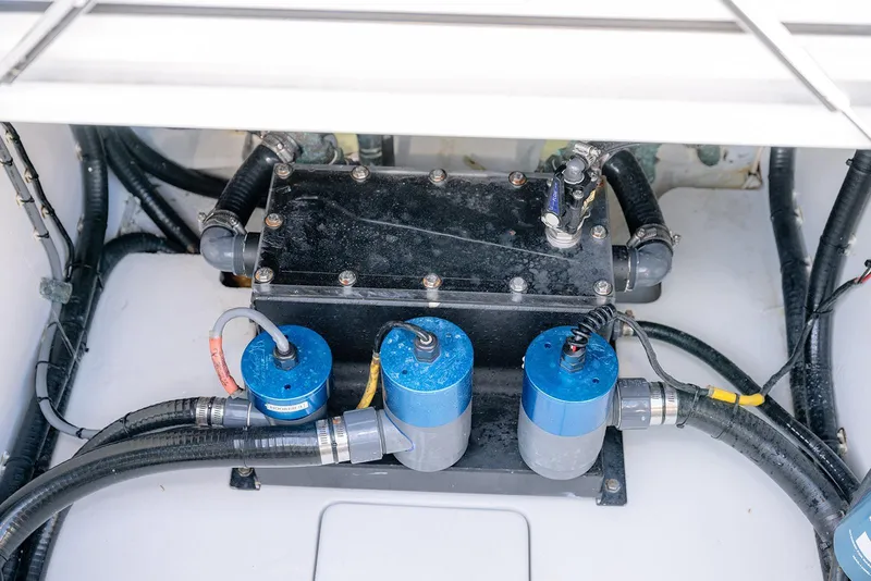Slide: The Image of Engine compartment of a 2020 Contender 44 ST boat, featuring pumps and hoses. - 36