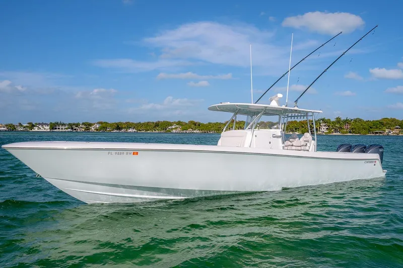 Slide: The Image of 2020 Contender 44 ST boat on clear water, featuring sleek design and multiple fishing rods. - 4