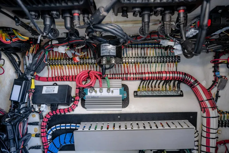 Slide: The Image of Electrical wiring system inside a 2020 Contender 44 ST boat, showcasing organized cables and components. - 41