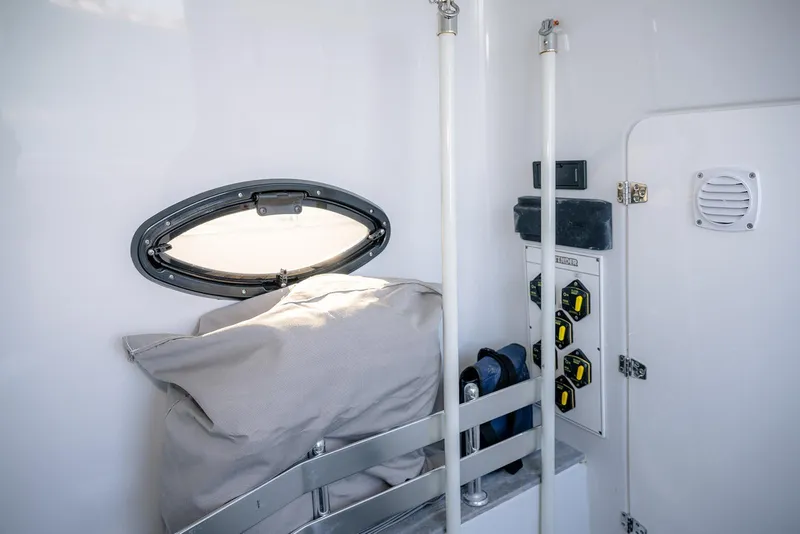 Slide: The Image of Interior of 2020 Contender 44 ST boat, featuring a porthole and control panel. - 43