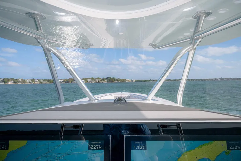 Slide: The Image of Cockpit view from a 2020 Contender 44 ST boat, navigating coastal waters. - 44