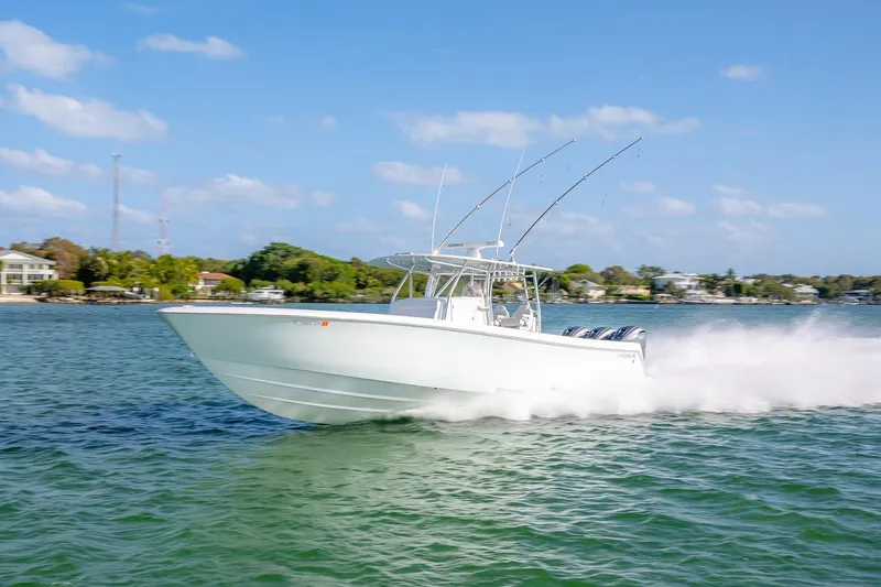 Slide: The Image of 2020 Contender 44 ST boat speeding on water, clear sky, coastal background. - 46