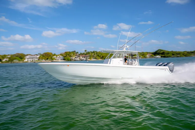 Slide: The Image of 2020 Contender 44 ST boat speeding on water under clear blue sky. - 47