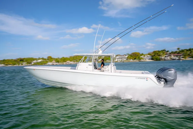 Slide: The Image of 2020 Contender 44 ST boat cruising on water with dual outboard engines. - 48