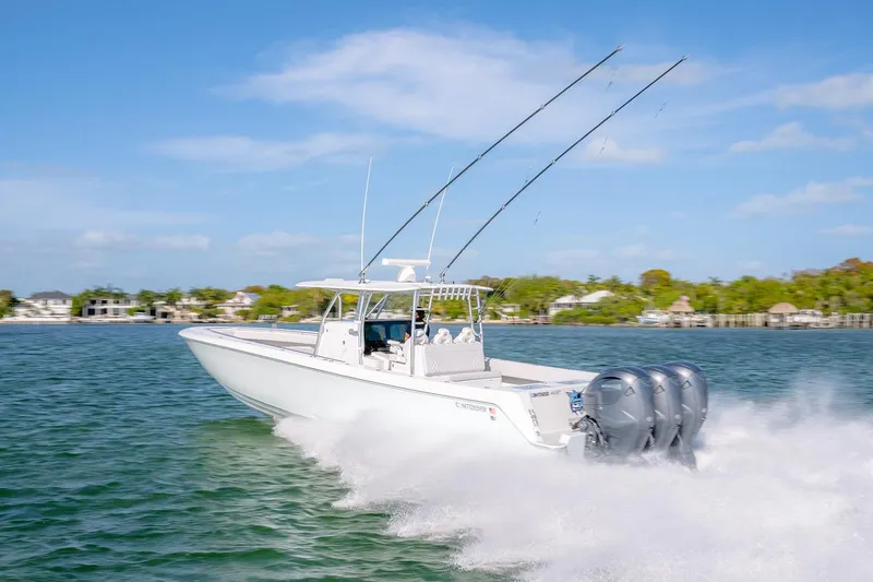 Slide: The Image of 2020 Contender 44 ST boat cruising on water with triple outboard engines. - 49