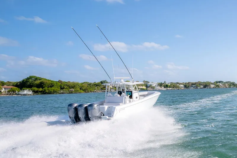 Slide: The Image of 2020 Contender 44 ST boat cruising on a sunny day with triple engines. - 52