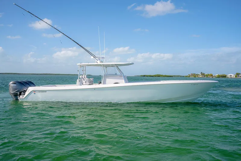 Slide: The Image of 2020 Contender 44 ST boat on clear blue water under a sunny sky. - 6