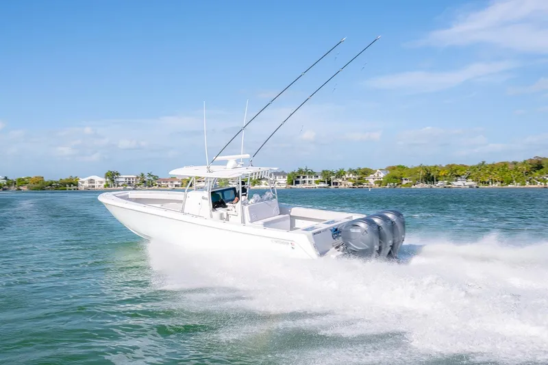 Slide: The Image of 2020 Contender 44 ST boat cruising on a sunny day with triple engines. - 7