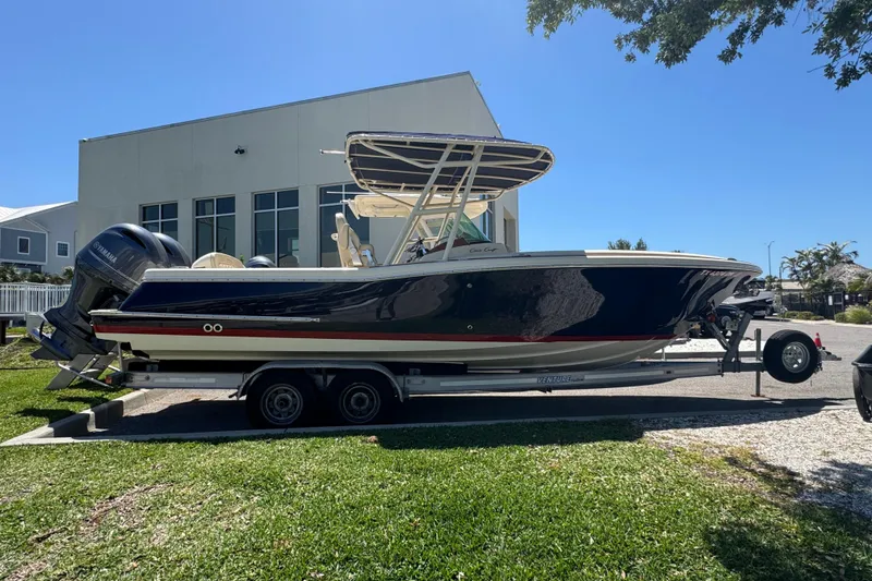 The Image of 2015 Chris-Craft Catalina 26 boat on trailer, parked outdoors near a building. - 1